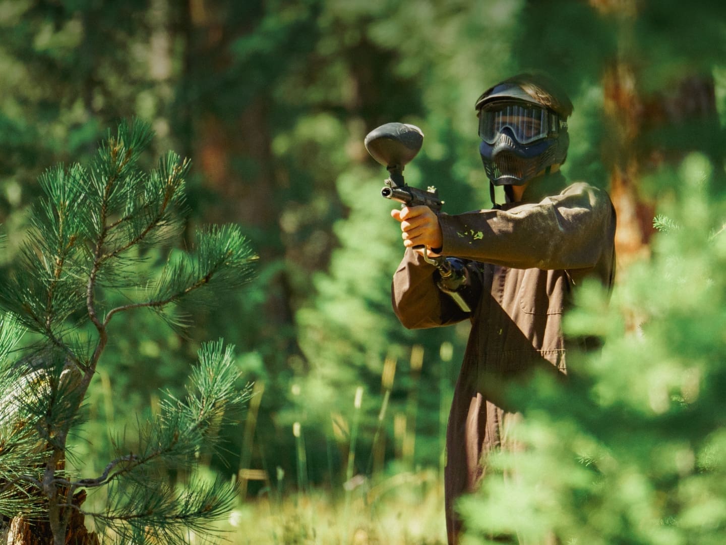 Paintball players on an outdoor field
